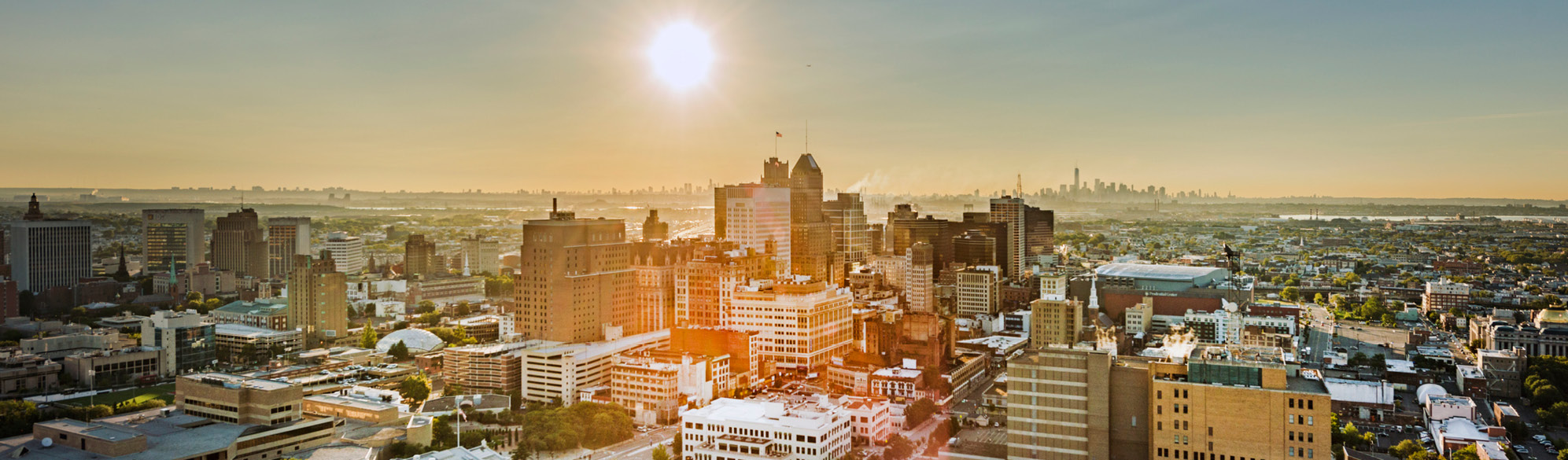 An aerial image of the City of Newark with the sun in the background.